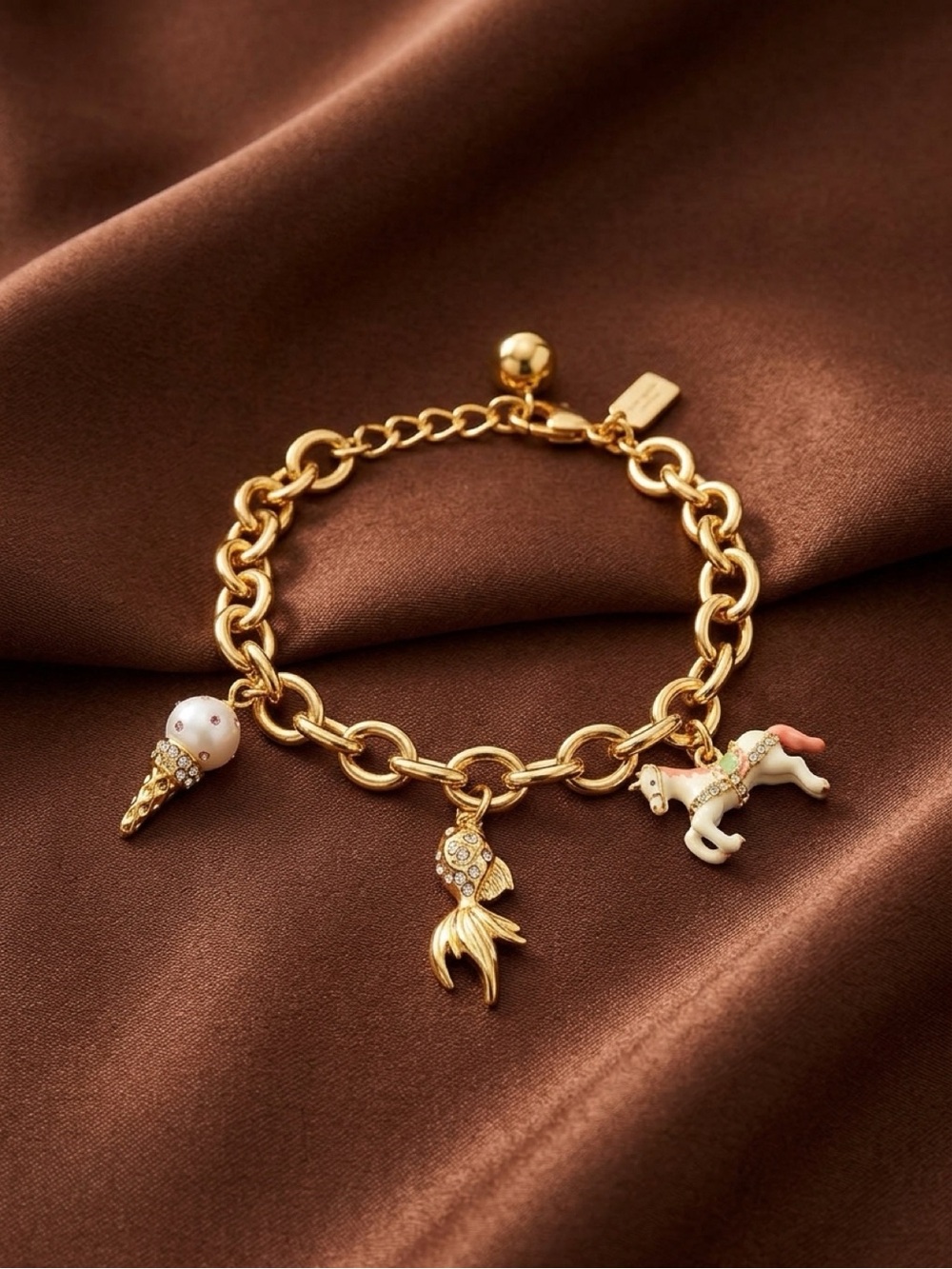 kate spade gold-tone kids charm bracelet with pastel pink and white charms
